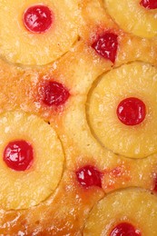 Photo of Tasty pineapple cake with cherries as background, top view