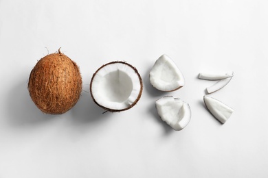 Photo of Pieces of coconut on white background, flat lay