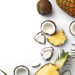 Photo of Composition with coconuts, juicy pineapples and leaves on white background, top view