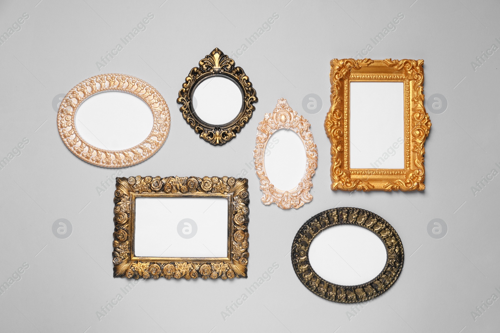 Photo of Empty vintage frames hanging on light gray wall