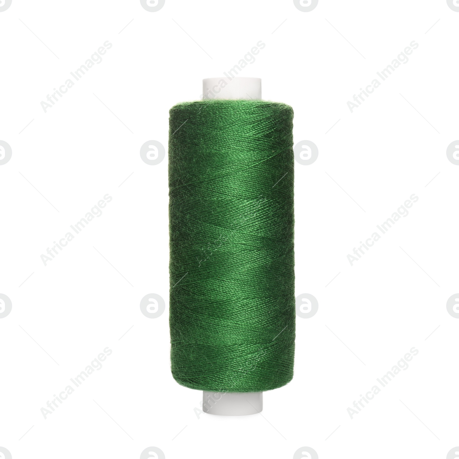 Photo of Spool of green sewing thread isolated on white