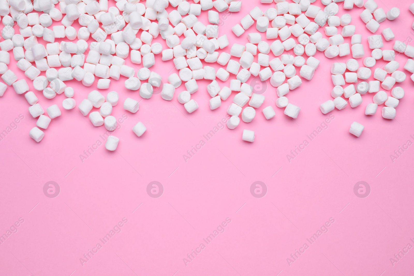 Photo of Delicious sweet marshmallows on pink background, flat lay. Space for text