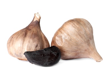 Aged black garlic on white background. Asian cuisine