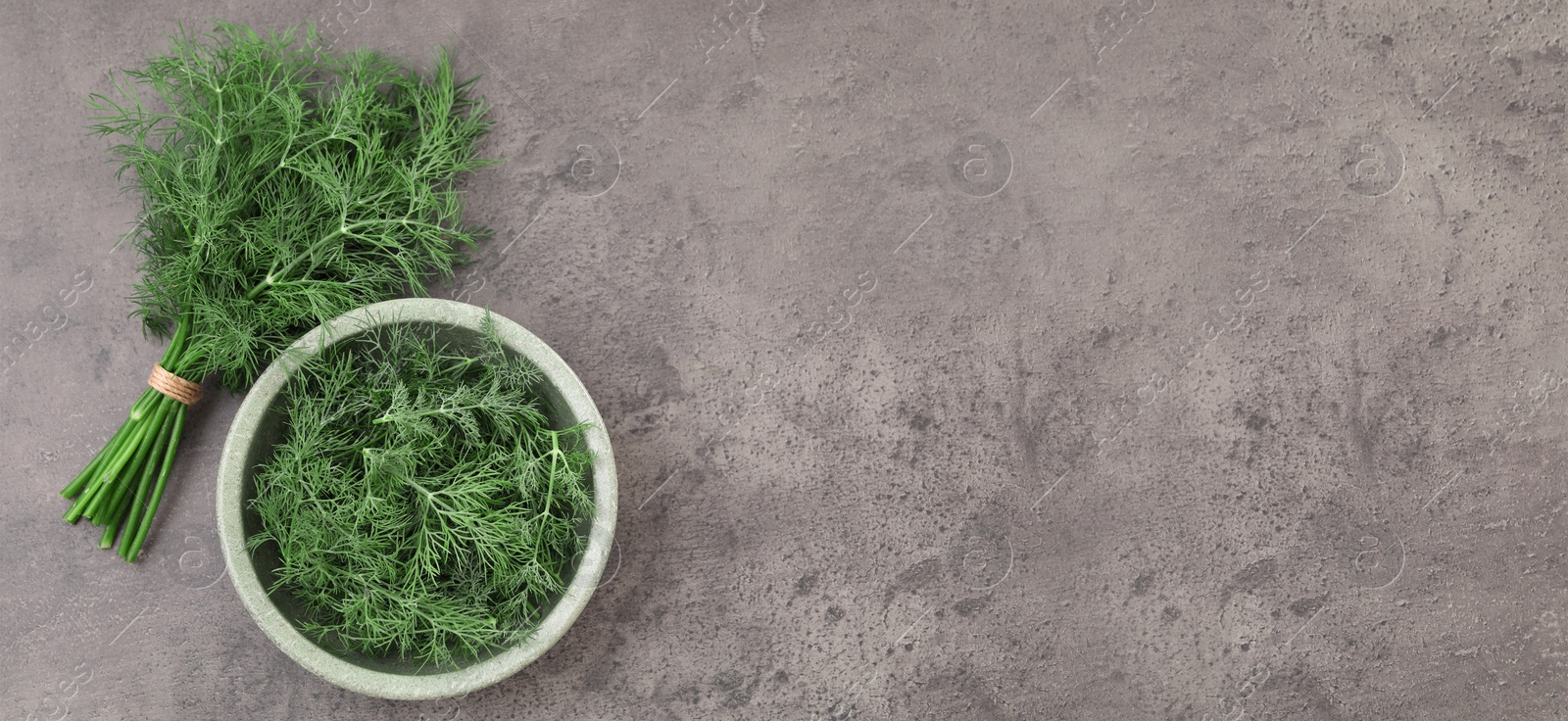 Image of Fresh dill on grey table, top view. Banner design with space for text