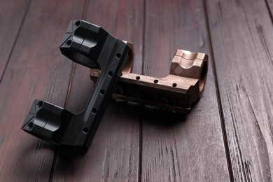 Photo of Quick disconnect sniper cantilever scope mounts on wooden table, closeup