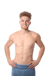 Portrait of young man with slim body in towel on white background