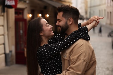 Lovely couple dancing together on city street