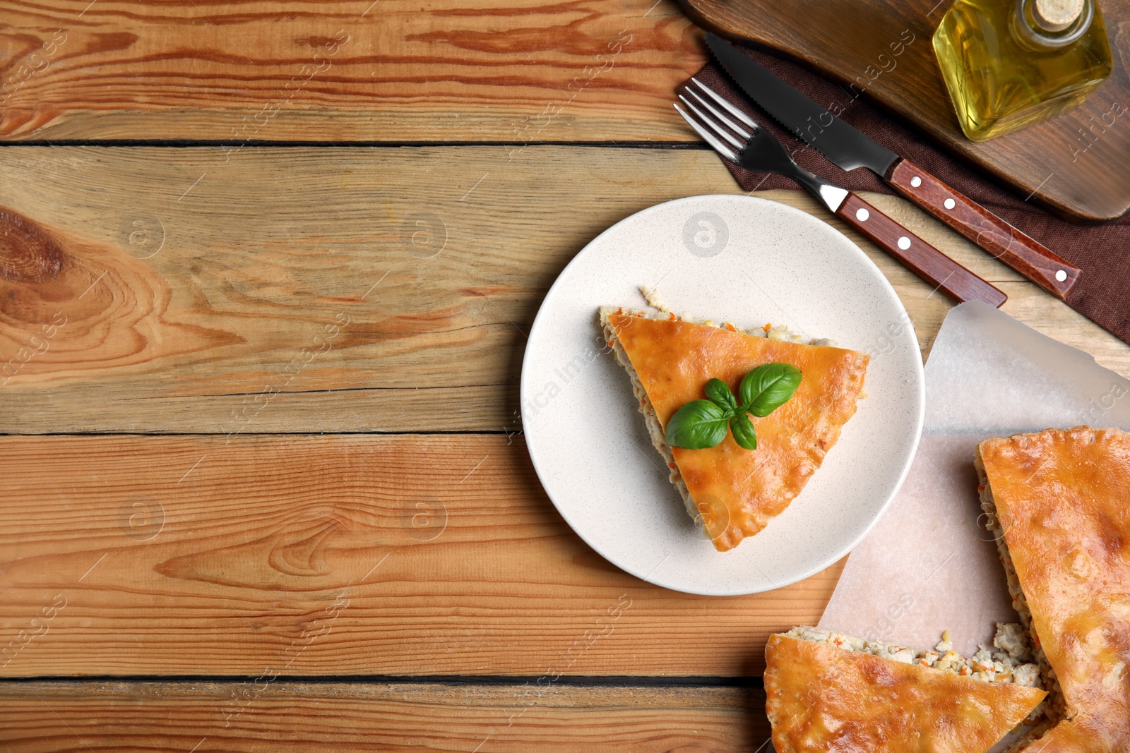 Photo of Delicious meat pie served on wooden table, flat lay. Space for text