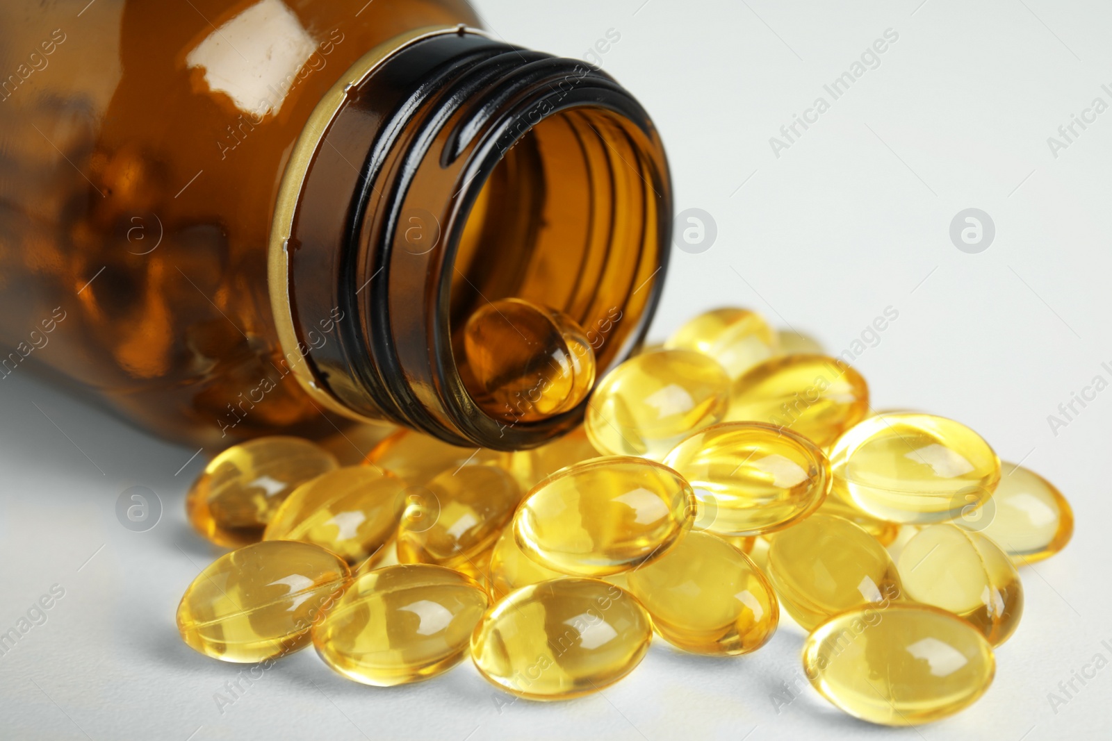 Photo of Bottle with cod liver oil pills on table, closeup