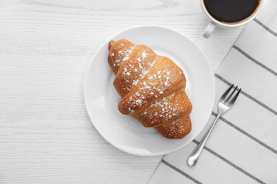 Photo of Delicious croissant and morning coffee on white wooden table, flat lay