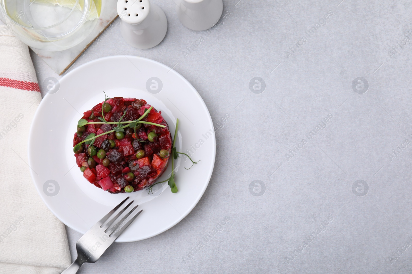 Photo of Delicious vinaigrette salad on light grey table, flat lay. Space for text