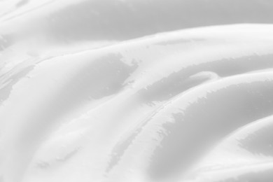 Photo of Texture of face cream as background, closeup view