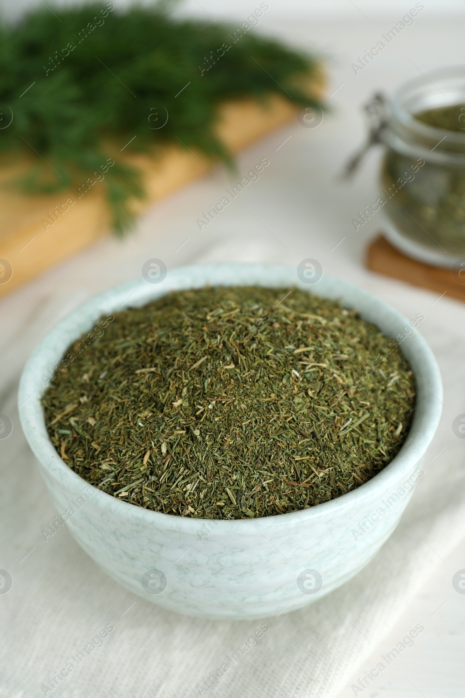 Photo of Dried dill in bowl on table, closeup