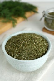 Dried dill in bowl on table, closeup