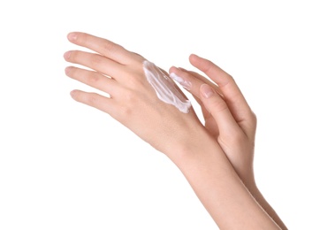 Young woman applying cream onto her hands on white background, closeup