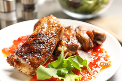 Photo of Delicious grilled ribs in plate, closeup view