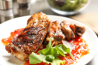 Delicious grilled ribs in plate, closeup view