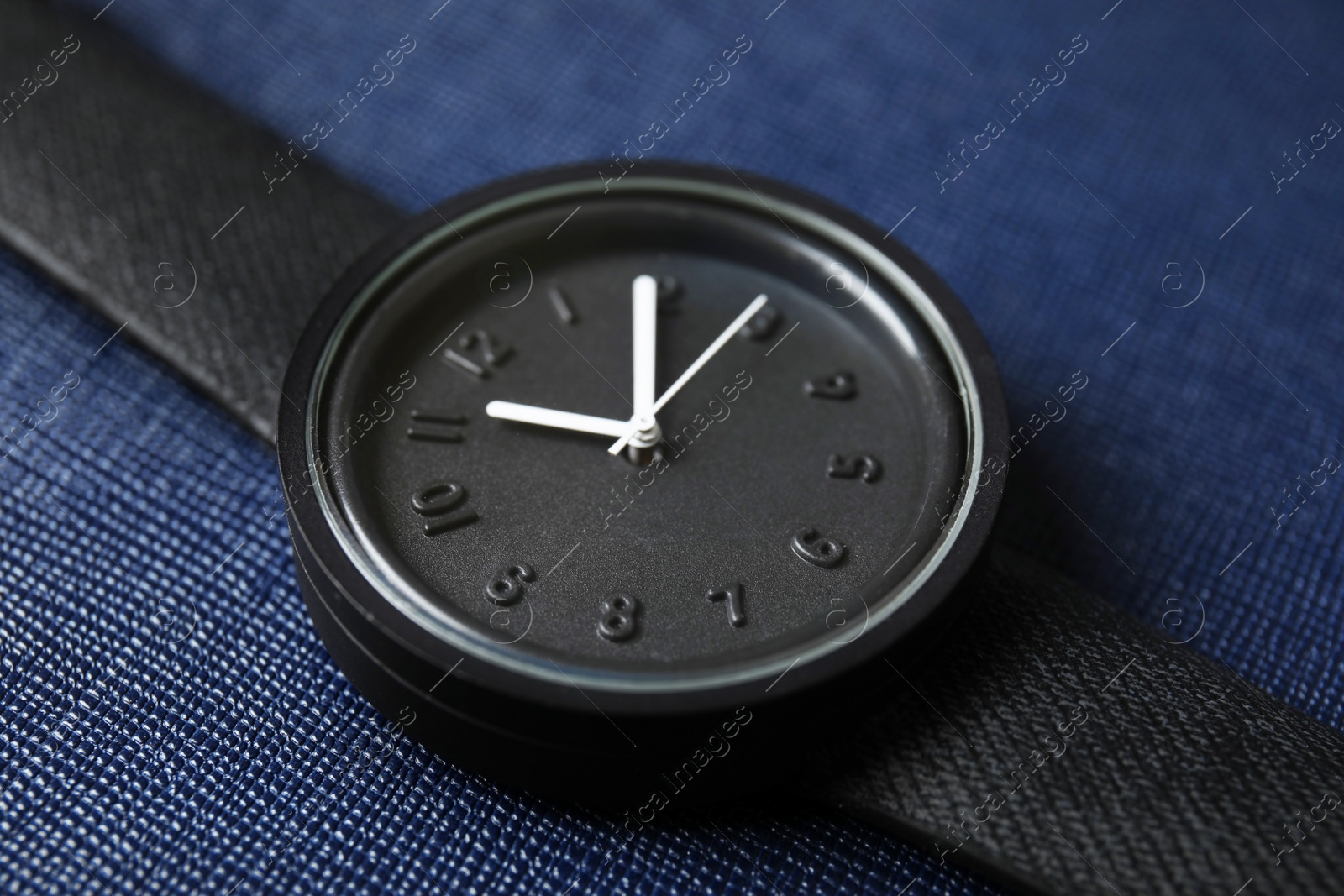 Photo of Stylish wrist watch on color background, closeup. Fashion accessory