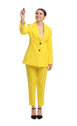 Beautiful businesswoman in yellow suit with marker on white background