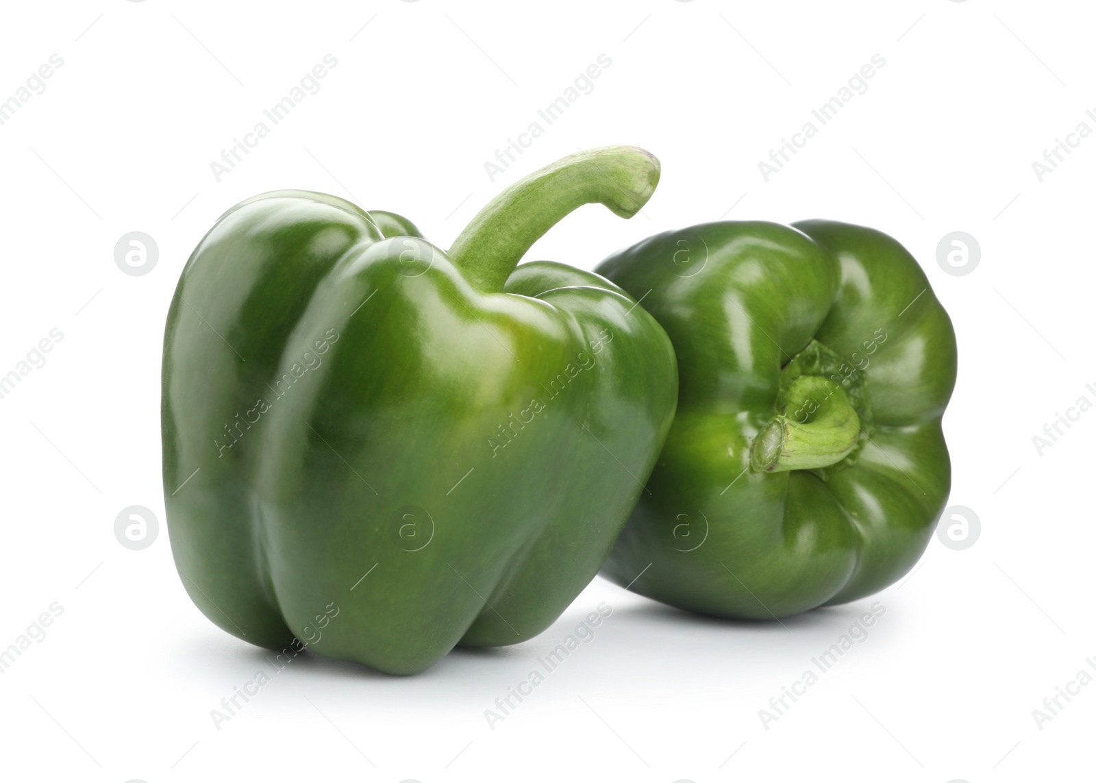 Photo of Ripe green bell peppers on white background