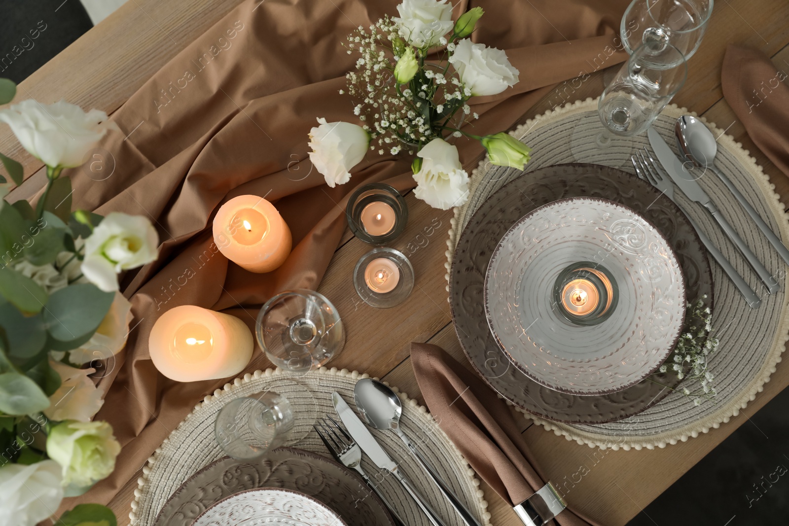 Photo of Festive table setting with beautiful candles and floral decor, flat lay