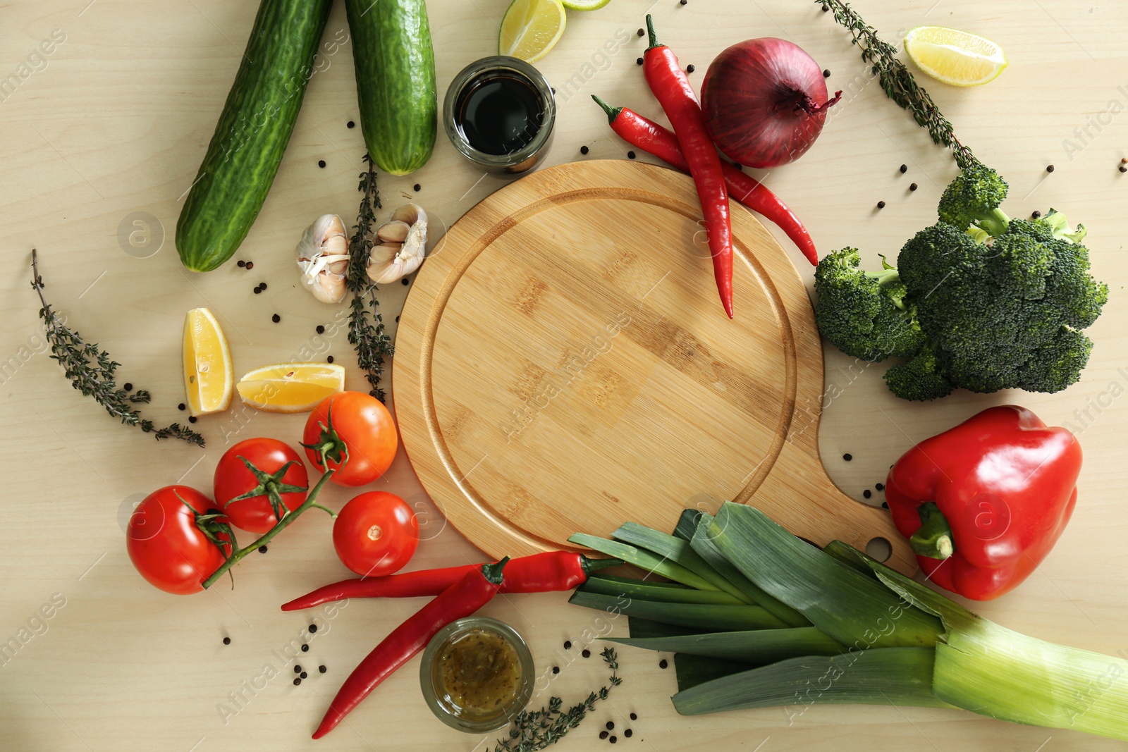 Photo of Fresh products and cutting board on wooden table, flat lay. Cooking healthy food