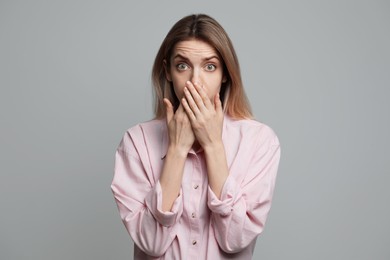 Photo of Young woman feeling fear on grey background