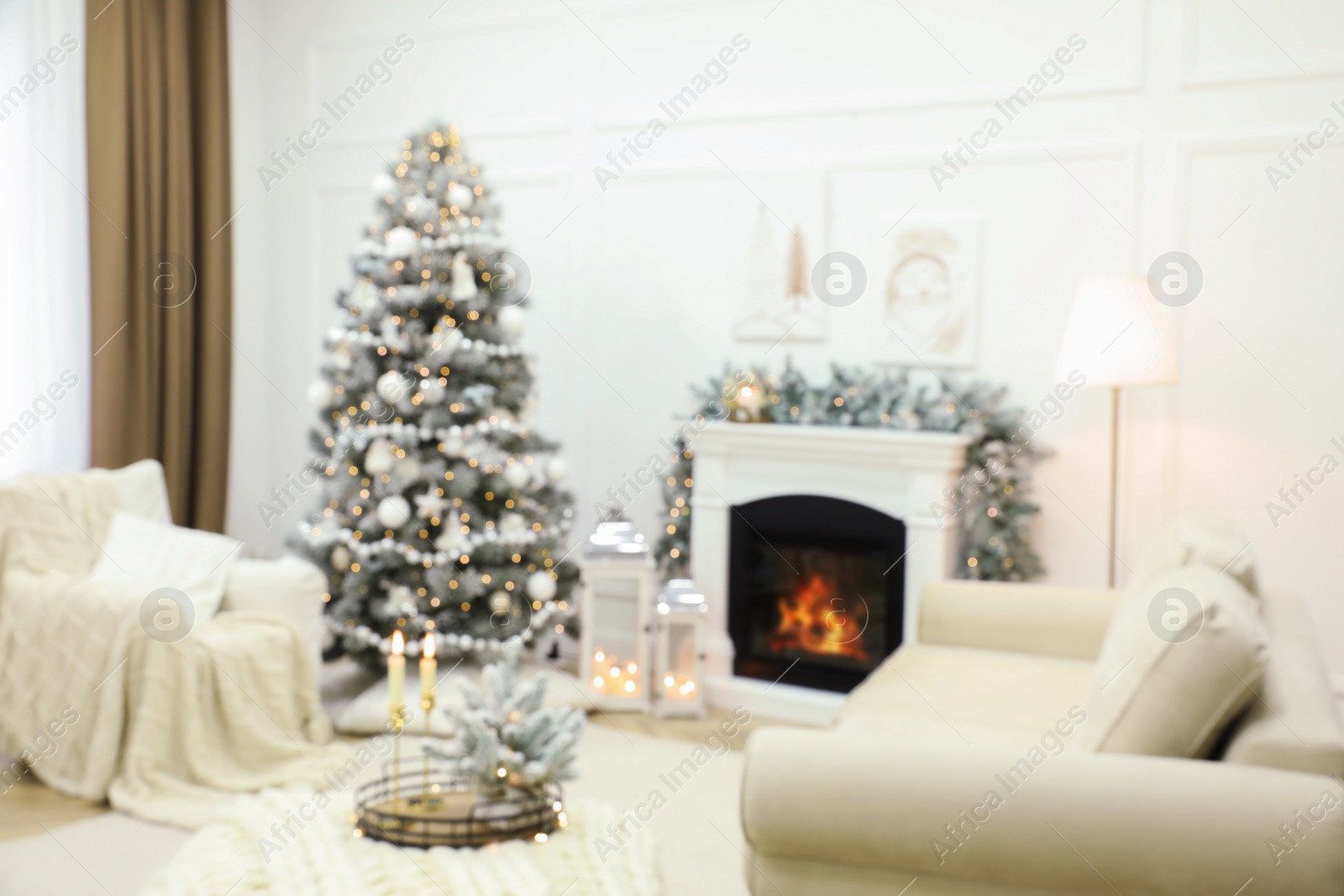 Photo of Blurred view of fireplace in living room decorated for Christmas