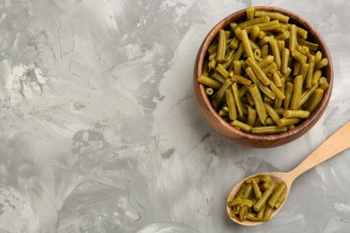 Canned green beans on grey table, flat lay. Space for text