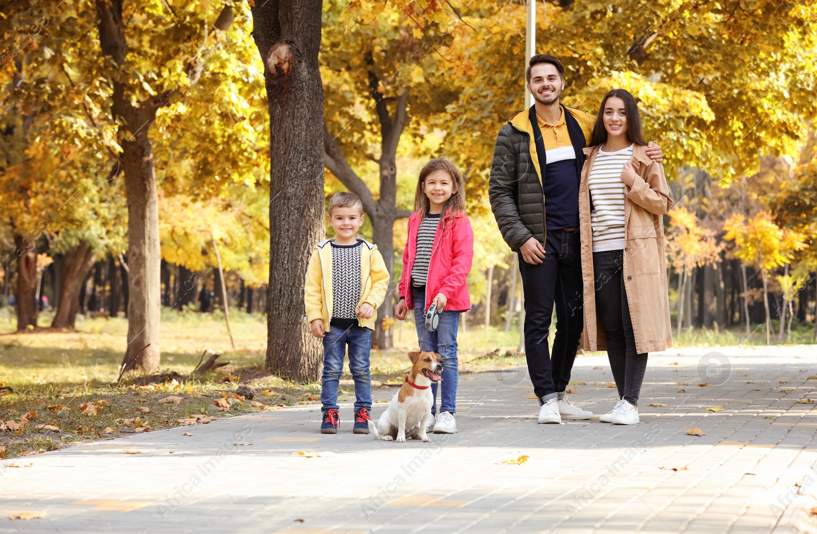 Photo of Happy family with children and dog in park. Autumn walk