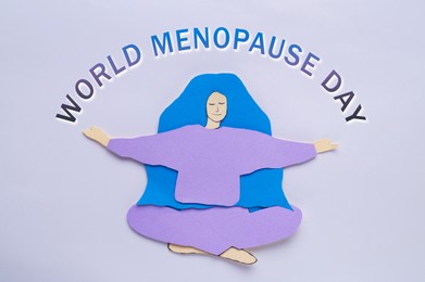 World Menopause Day. Paper woman on white background, top view
