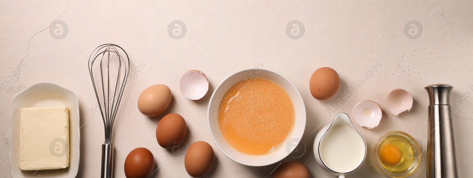 Image of Metal whisk and and dough ingredients on light table, flat lay. Banner design