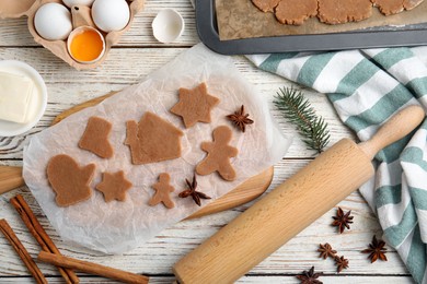 Photo of Making Christmas cookies. Flat lay composition with raw dough and ingredients on white wooden table