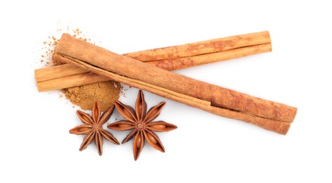 Dry aromatic cinnamon sticks, powder and anise stars isolated on white, top view