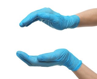 Doctor wearing light blue medical gloves holding something on white background, closeup