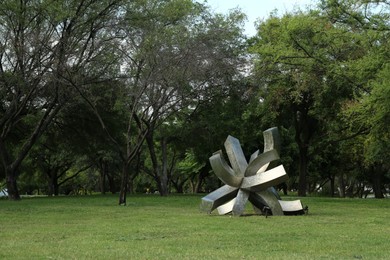 Photo of Picturesque view of beautiful park with metal figure on green grass