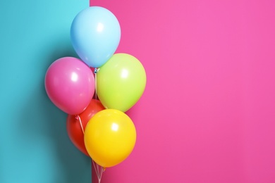 Bright air balloons for birthday party on color background