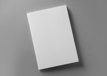 Brochure with blank cover on light grey background, top view