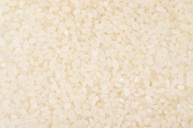 Photo of Raw polished rice as background, top view
