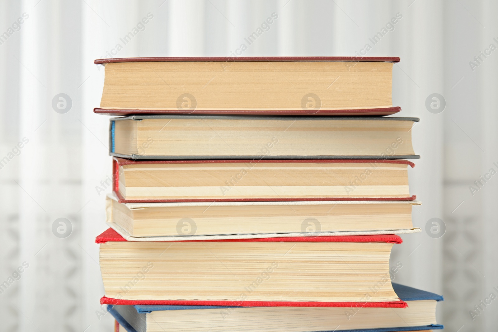 Photo of Collection of different hardcover books indoors, closeup