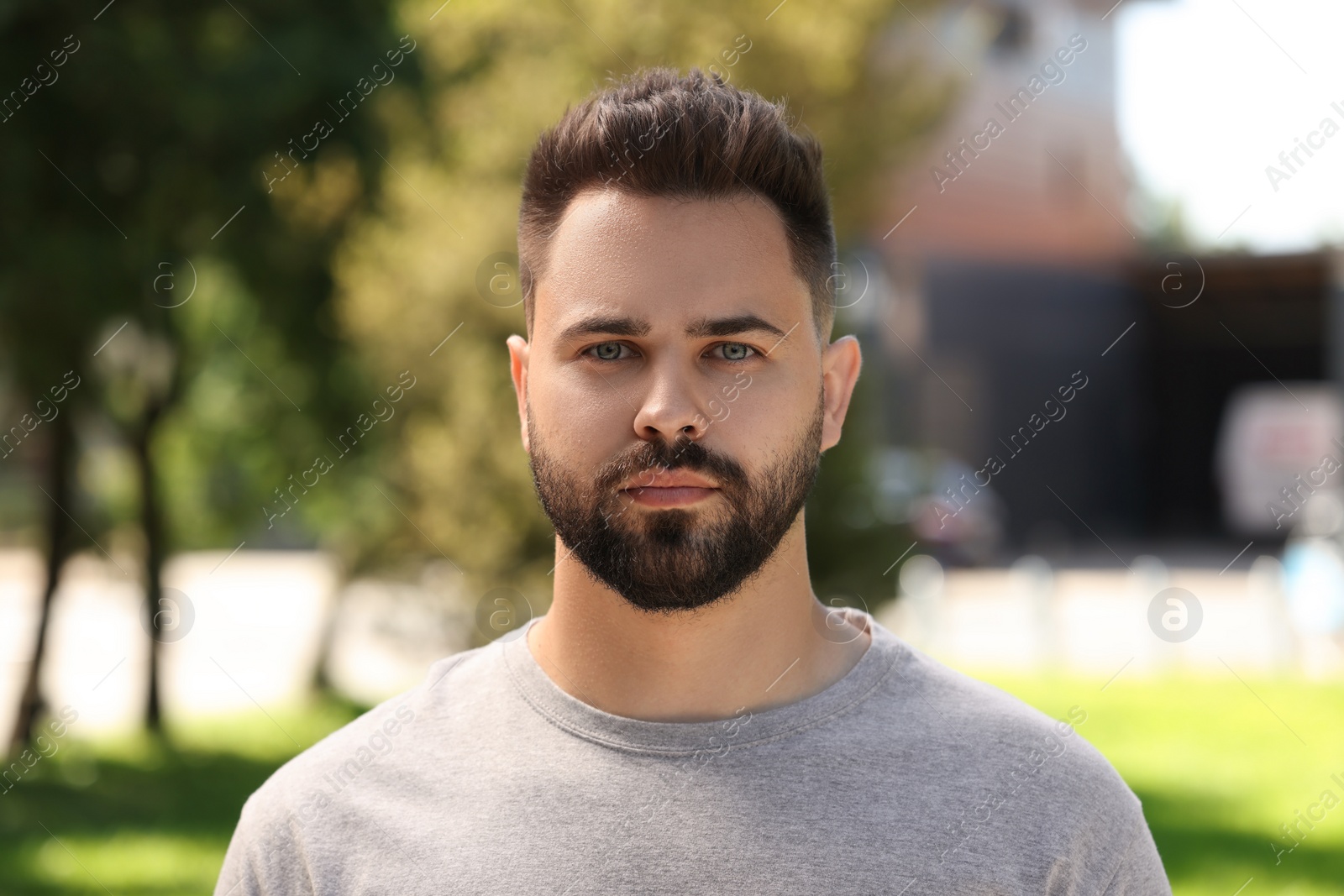 Photo of Portrait of handsome young man outdoors on sunny day