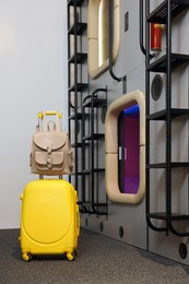 Photo of Luggage near capsules in modern pod hostel