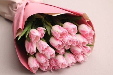 Photo of Beautiful bouquet of fresh pink tulips on light background