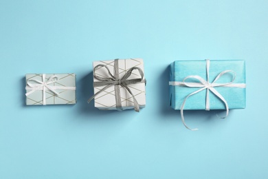 Photo of Flat lay composition with beautiful gift boxes on color background