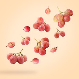 Image of Fresh grapes in air on light orange background