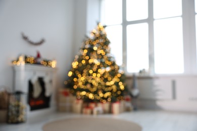 Photo of Blurred view of many different gift boxes under Christmas tree and festive decor in living room