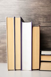 Photo of Collection of different books on white shelf