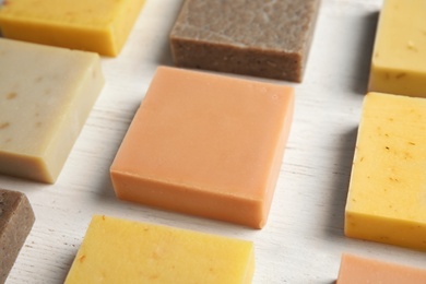 Photo of Hand made soap bars on white wooden background