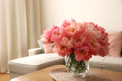 Photo of Beautiful pink peonies in vase on table at home, space for text. Interior design