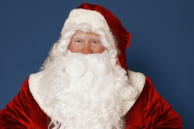 Photo of Happy authentic Santa Claus on blue background
